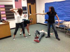 Students have fun making tableaux