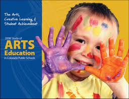 A young boy paints in an arts in education poster