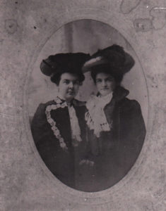 Two Victorian women pose for photograph