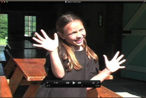 A still image from a video of a girl waving her hands