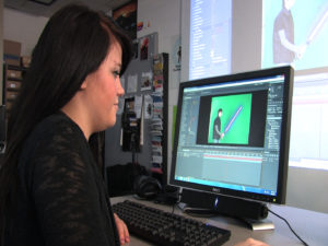 Girl editing green screen on her computer
