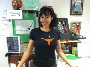 Holly Adams in her Longhorn tee-shirt in front of her desk