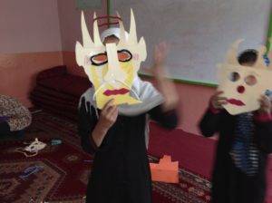 Children in Kabul using the masks they made