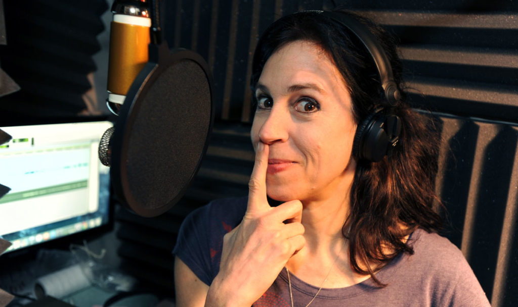 Holly Adams, voice over actor, plays in her home studio