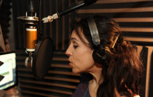 Holly Adams in her studio recording an audiobook
