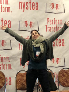 Holly Adams standing in front of a NYSTEA banner at a conference