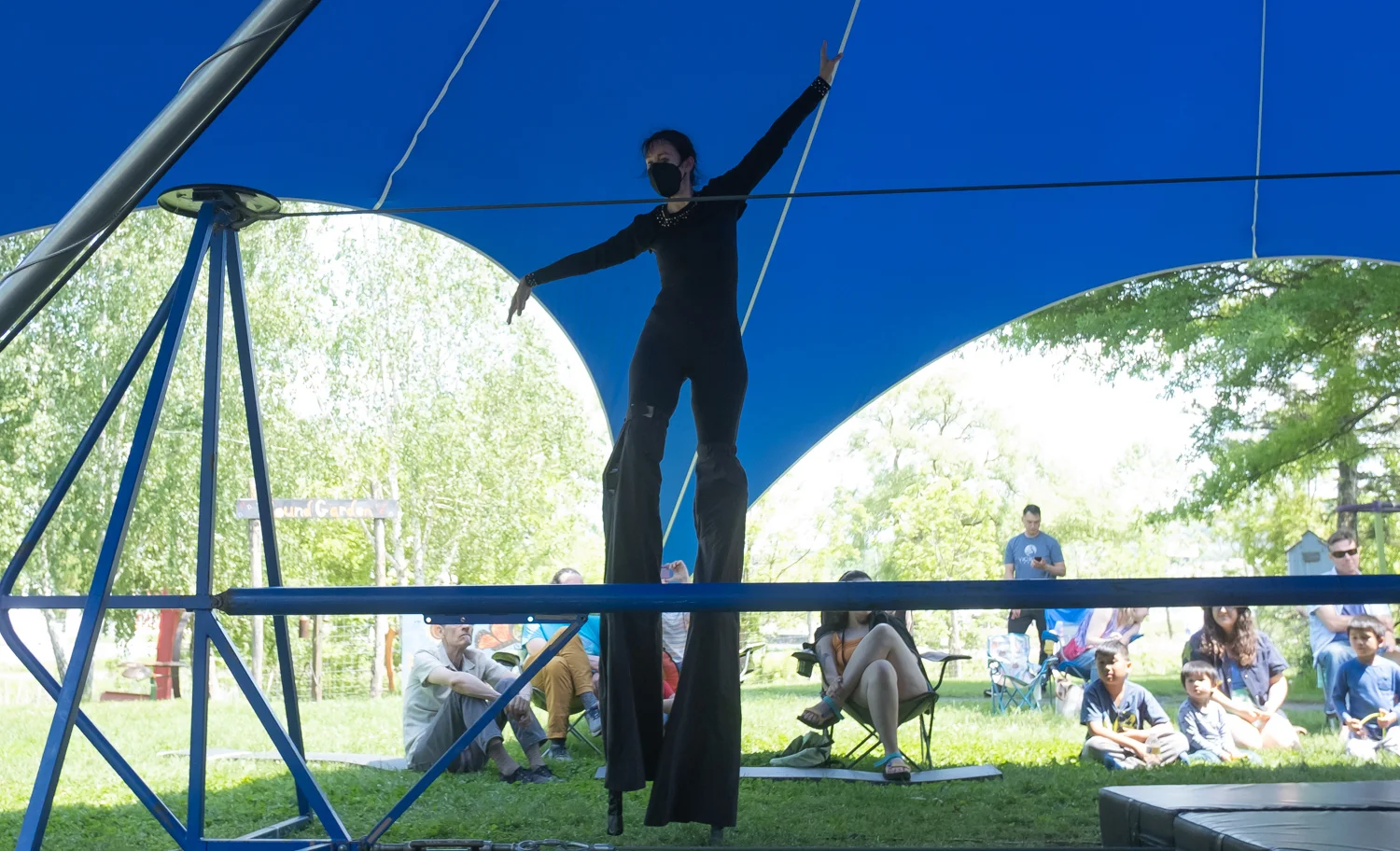 Holly on stilts in a circus tent